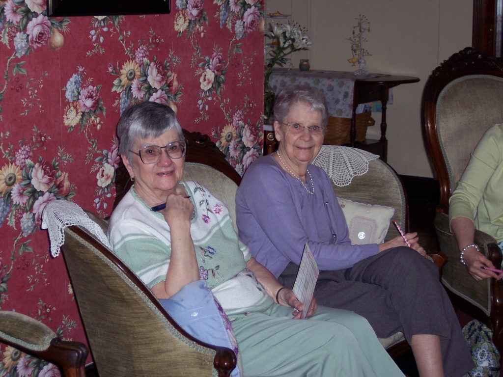 A photo of Gram and Grandma sharing a love seat at Kelsey's baby shower in 2010.