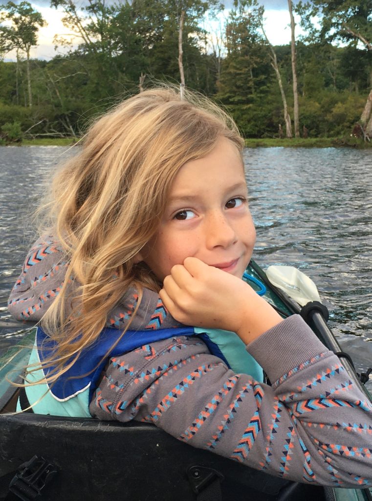 Dillon posing for a photo from the front seat of the tandem kayak.