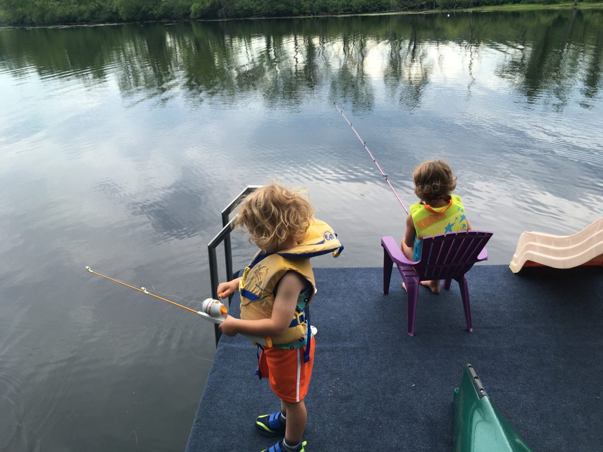 Grayson and Ainsley fishing on the dock.