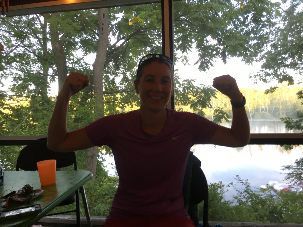 Kelsey in an exhausted victory pose with fists in the air on the back porch.