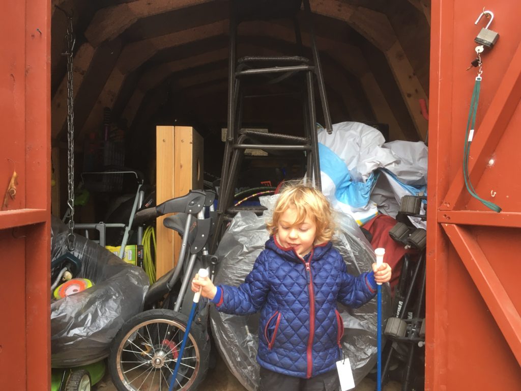 Grayson posing outside of the shed, now full of summer stuff.