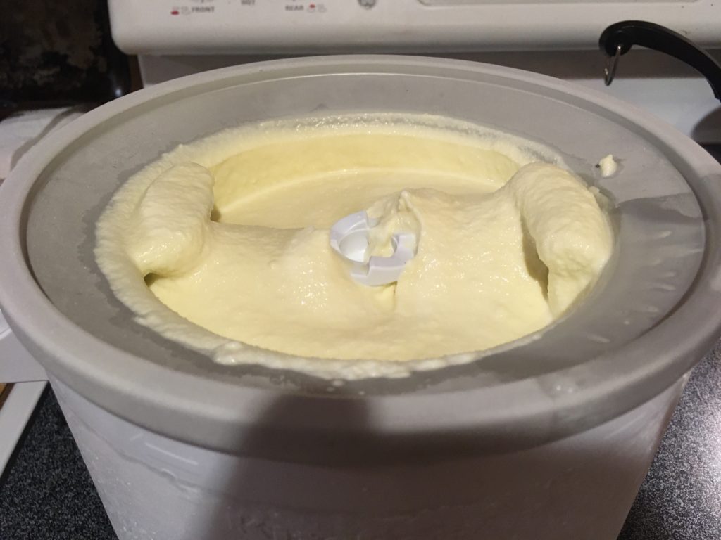 A photo of churned vanilla ice cream in the Kitchen Aid ice cream maker attachment