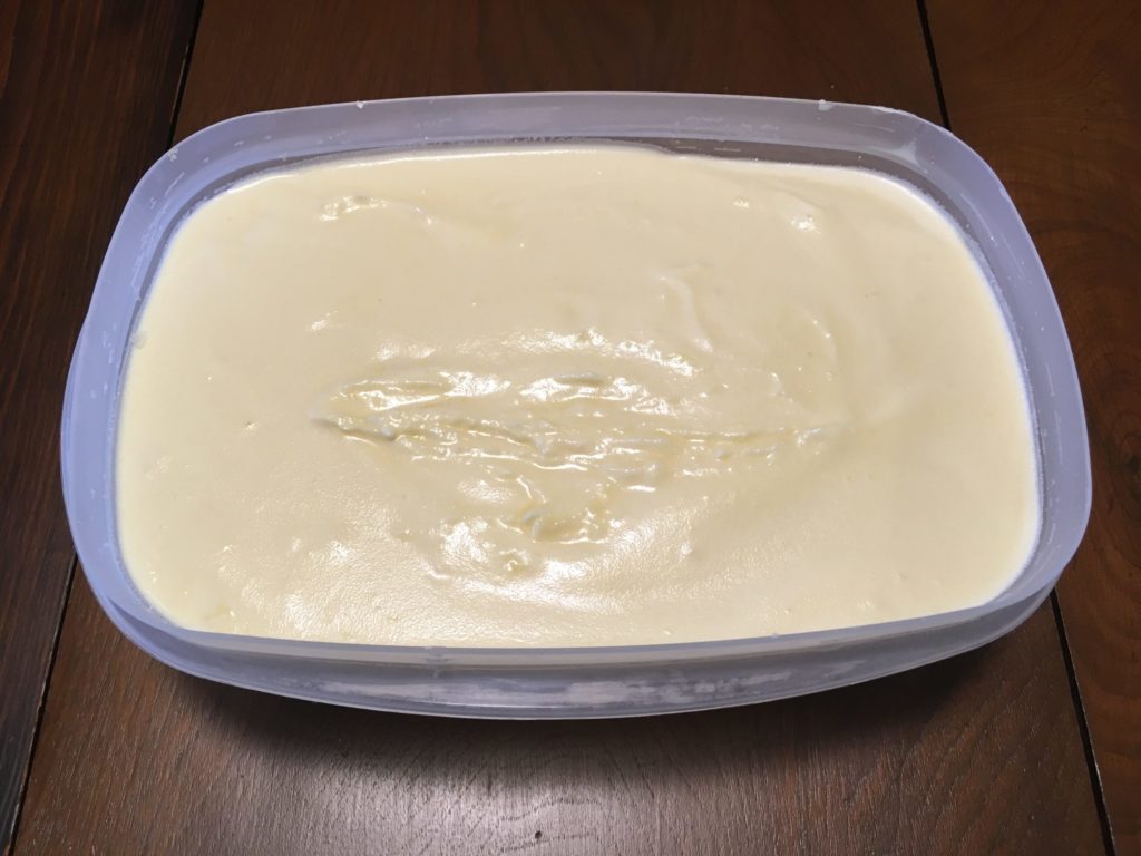 A photo of finished ice cream in a plastic container after freezing.