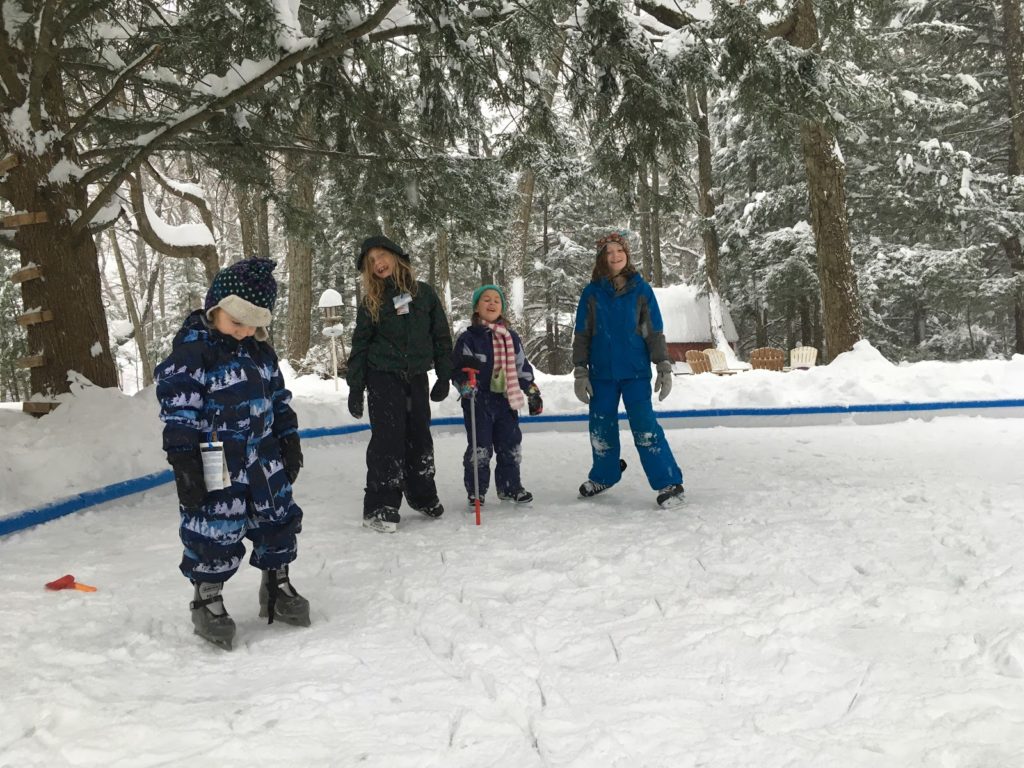 A photo of Grayson, Dillon, Ainsley, and Rayleigh skating on the rink for the first time.