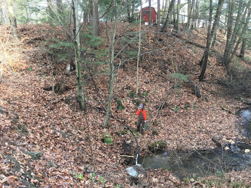 A photo of the sump pump connection leading to the pipe that goes up the hill to the rink.