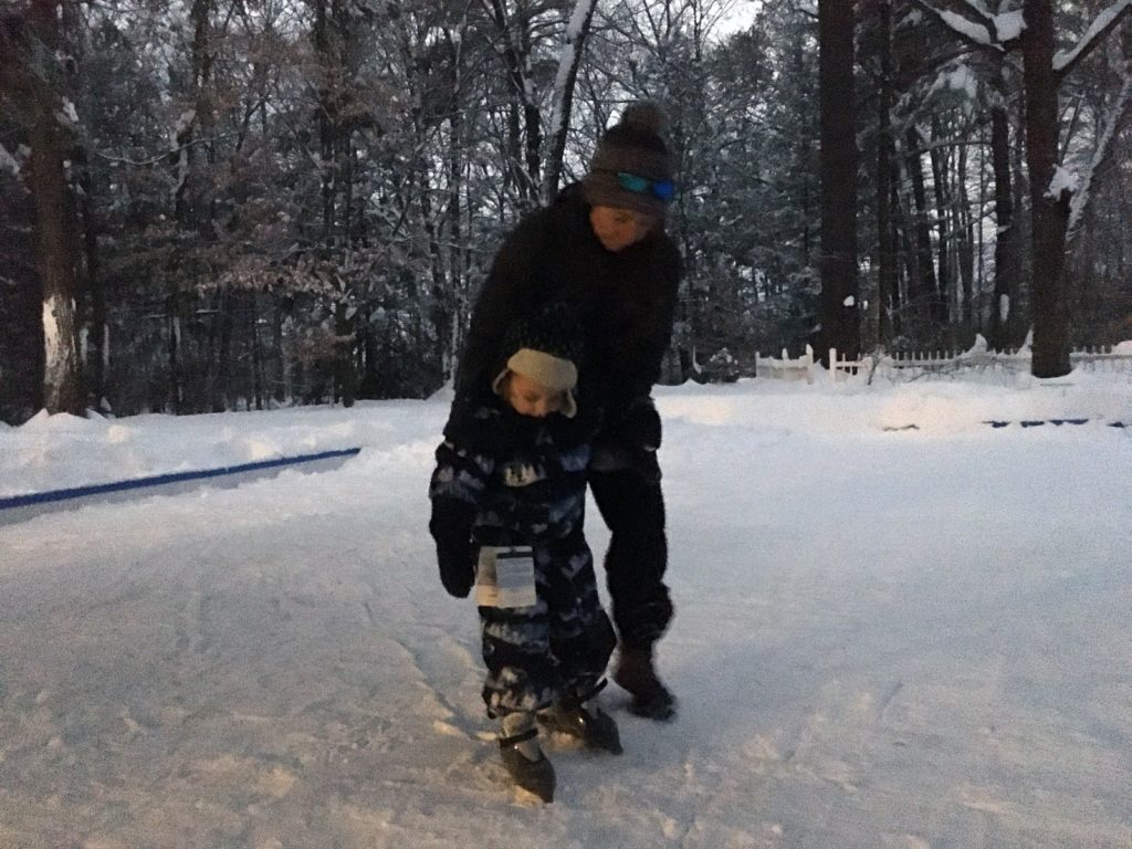 A photo of Kelsey teaching Grayson how to skate.