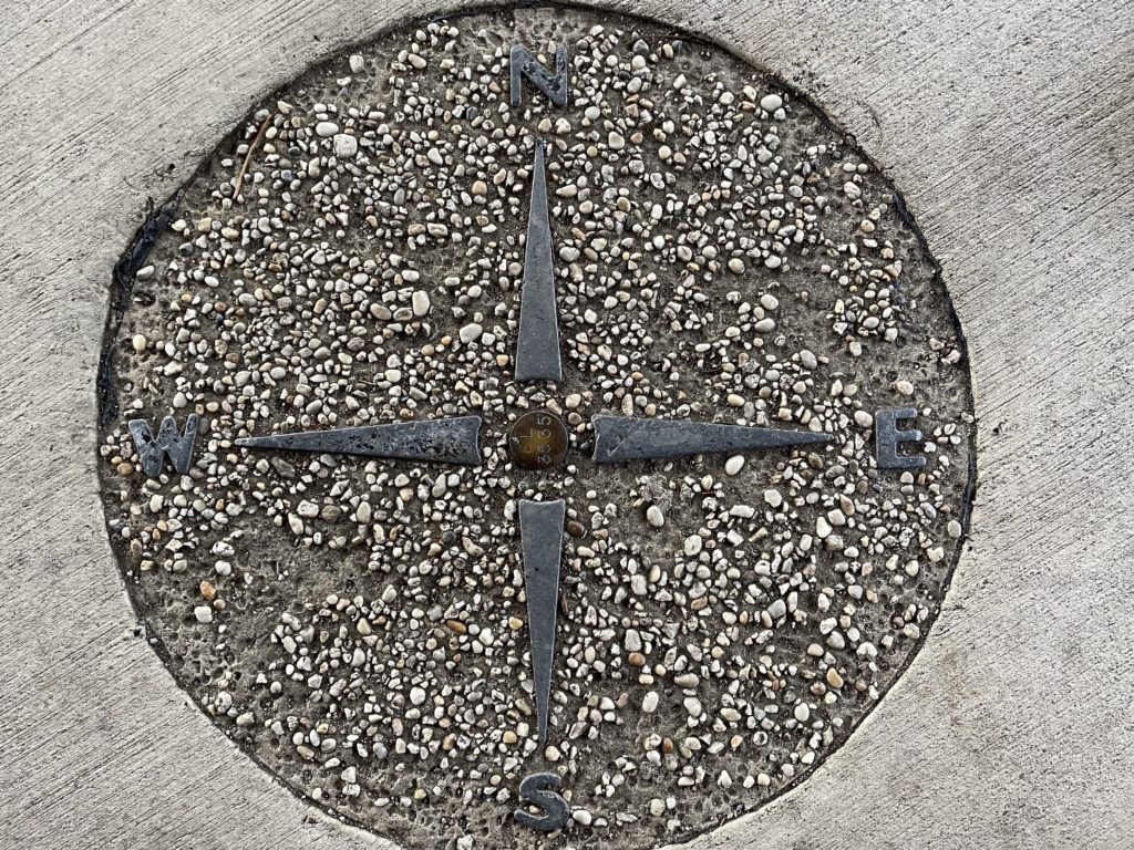 A photo of a compass rose embedded in concrete in Shenandoah National Park