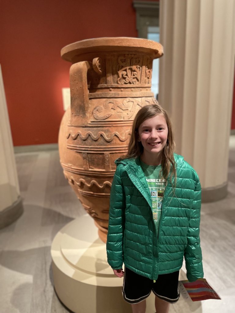 A photo of Dillon in front of a large vase in the Virginia Museum of Fine Arts