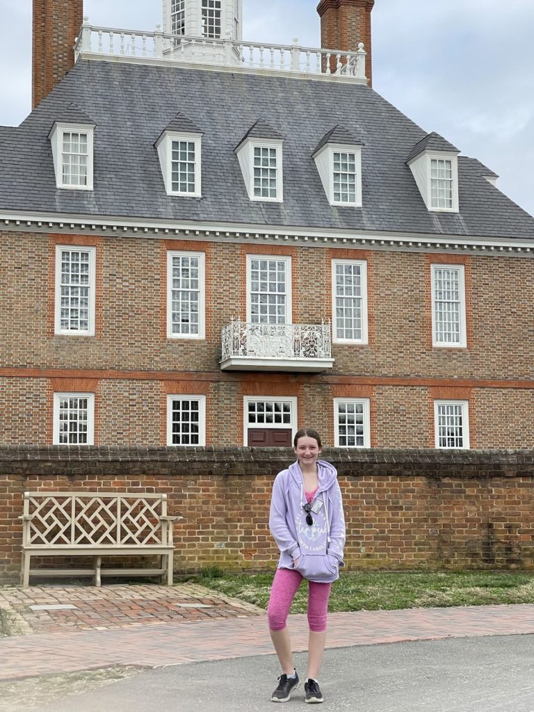 A photo of Rayleigh outside of the Governor's Palace in Colonial Williamsburg