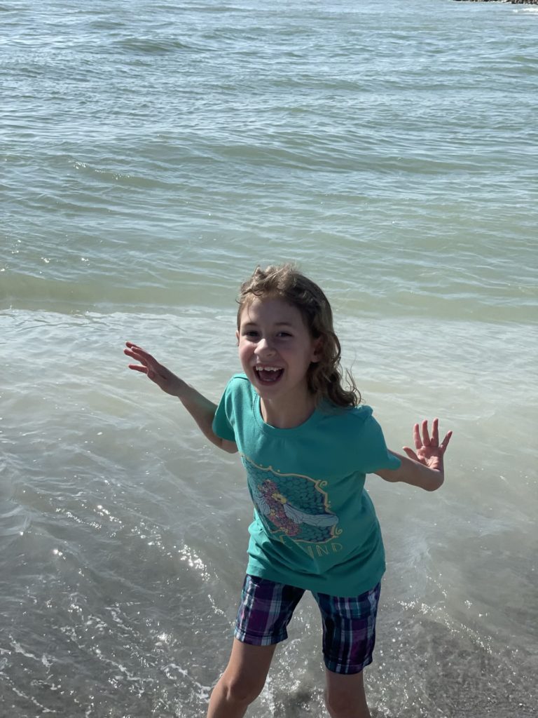 A photo of Ainsley splashing in the ocean