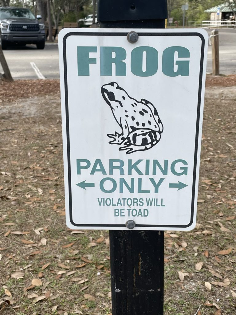 A photo of a sign that says "frog parking only: violators will be toad"