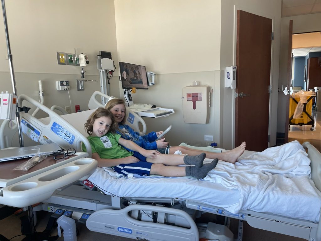 A photo of Grayson and Dillon relaxing on Grandpa's hospital bed