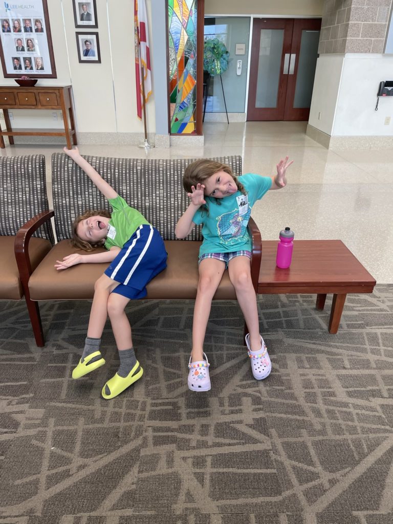 A photo of Grayson and Ainsley making silly faces in the lobby of the hospital
