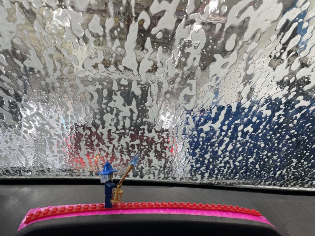 A photo of the van windshield covered in soap from the car wash