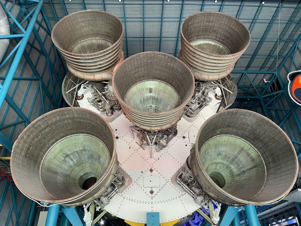 A photo of the five thruster cones at the end of a Saturn V rocket