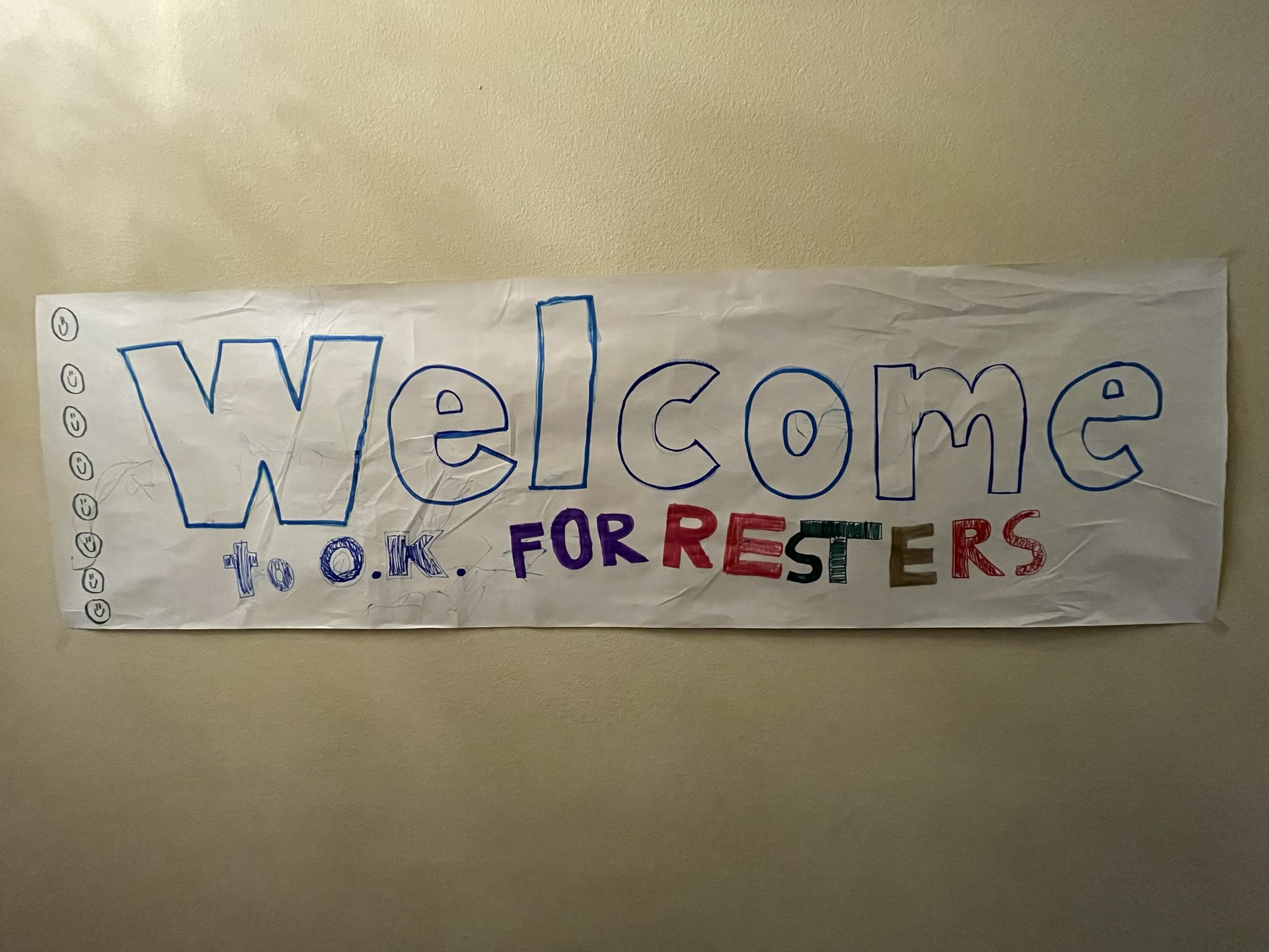 A photo of a homemade sign tacked to a wall that says "Welcome to O.K., Forresters"