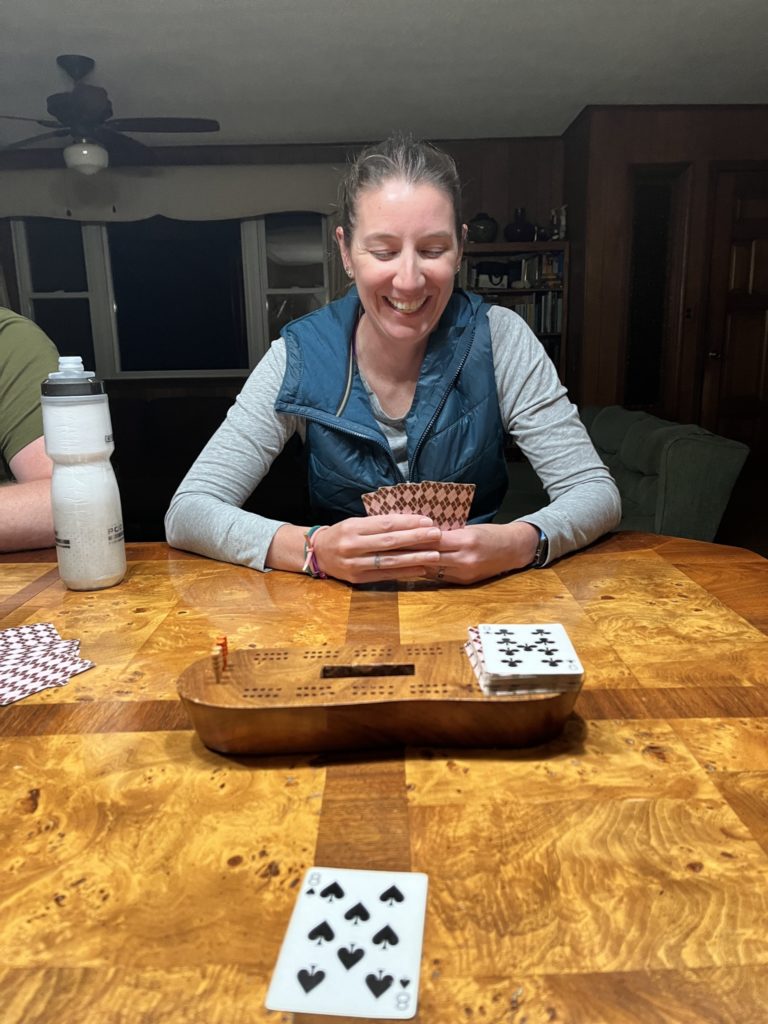 A photo of Kelsey laughing while playing cribbage