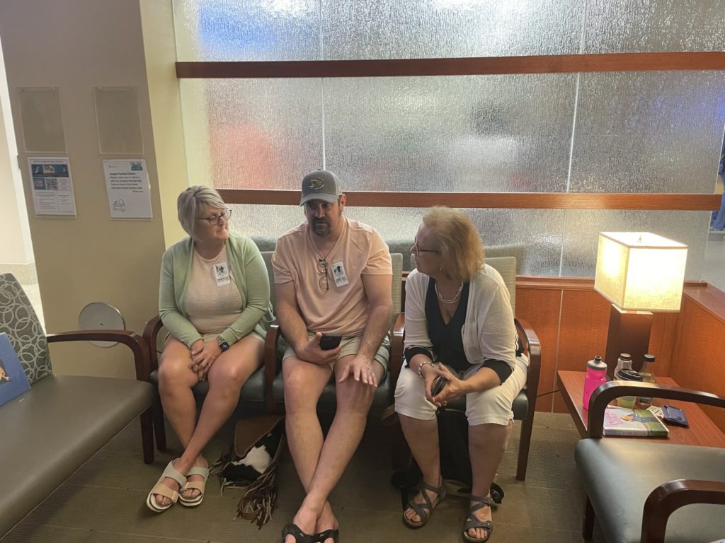 A photo of Aunt Traci, Uncle Shawn, and Grammy in the hospital waiting room