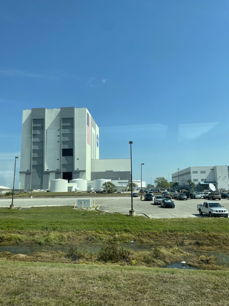 A photo of the Vehicle Assembly Building at Kennedy Space Center, which is a square concrete building that is over 500 feet tall
