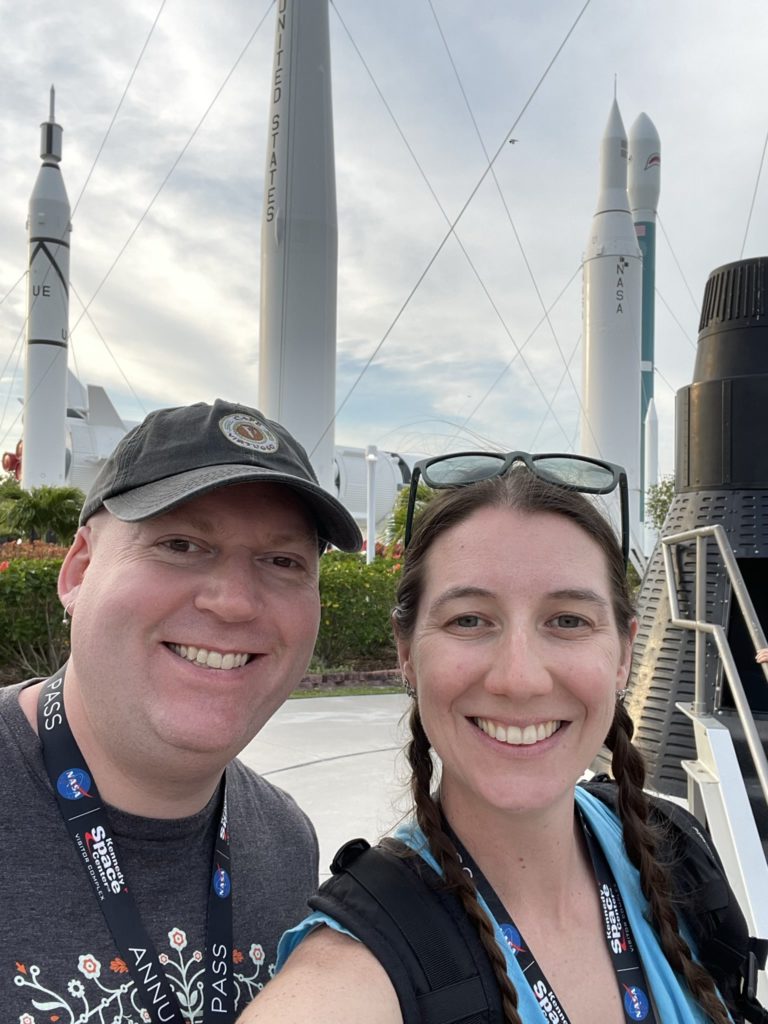 A photo of Kevin and Kelsey with the Rocket Garden in the background