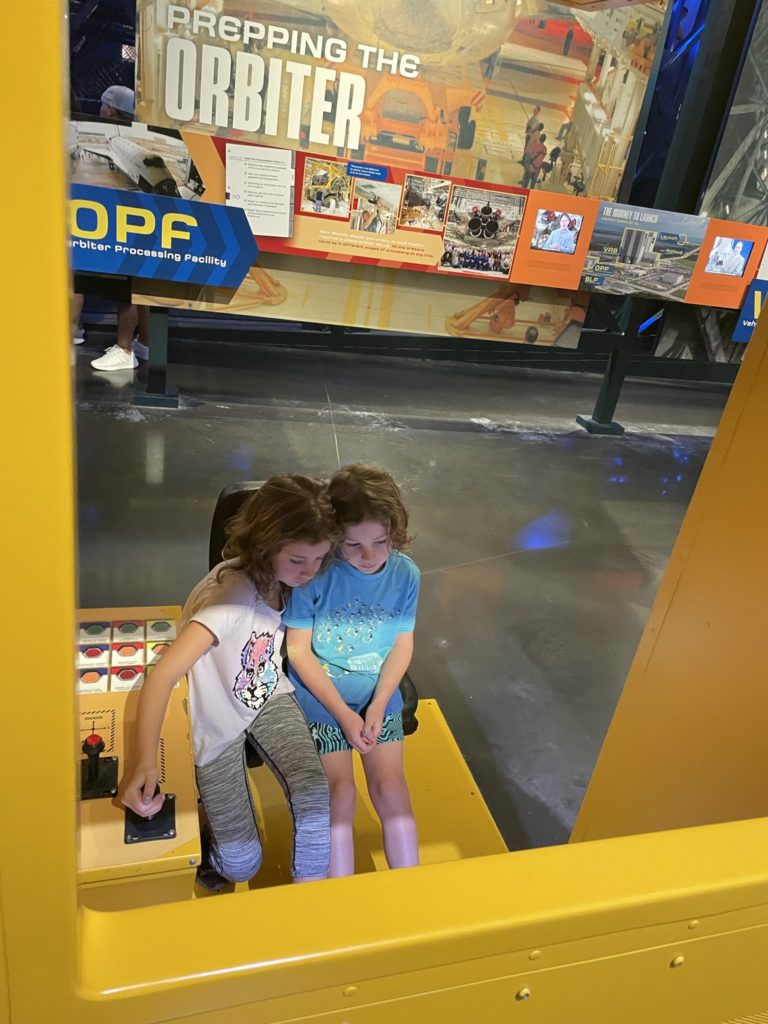A photo of Ainsley and Grayson operating the fuel booster crane simulator together