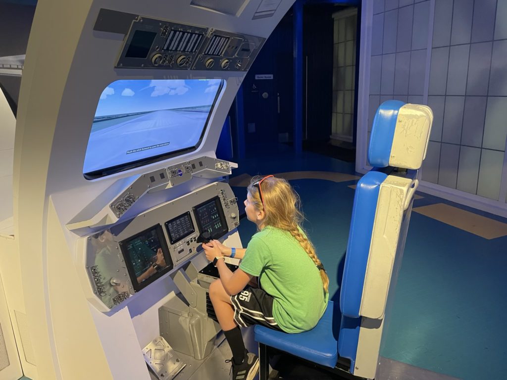 A photo of Dillon operating the shuttle landing simulator