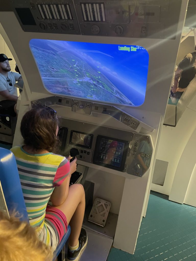 A photo of Rayleigh operating the space shuttle landing simulator