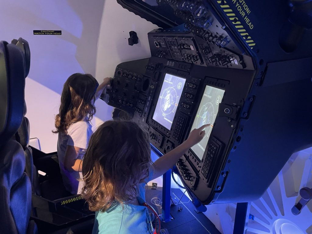 A photo of Ainsley and Grayson operating a simulator.
