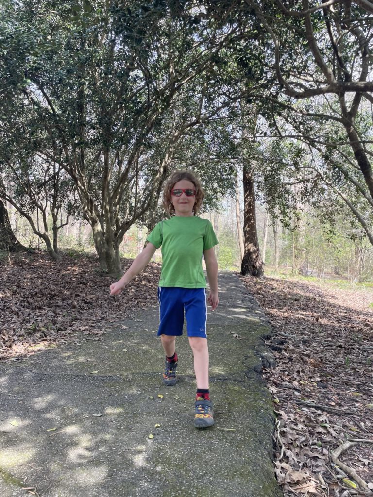 A photo of Grayson strutting down a forest path