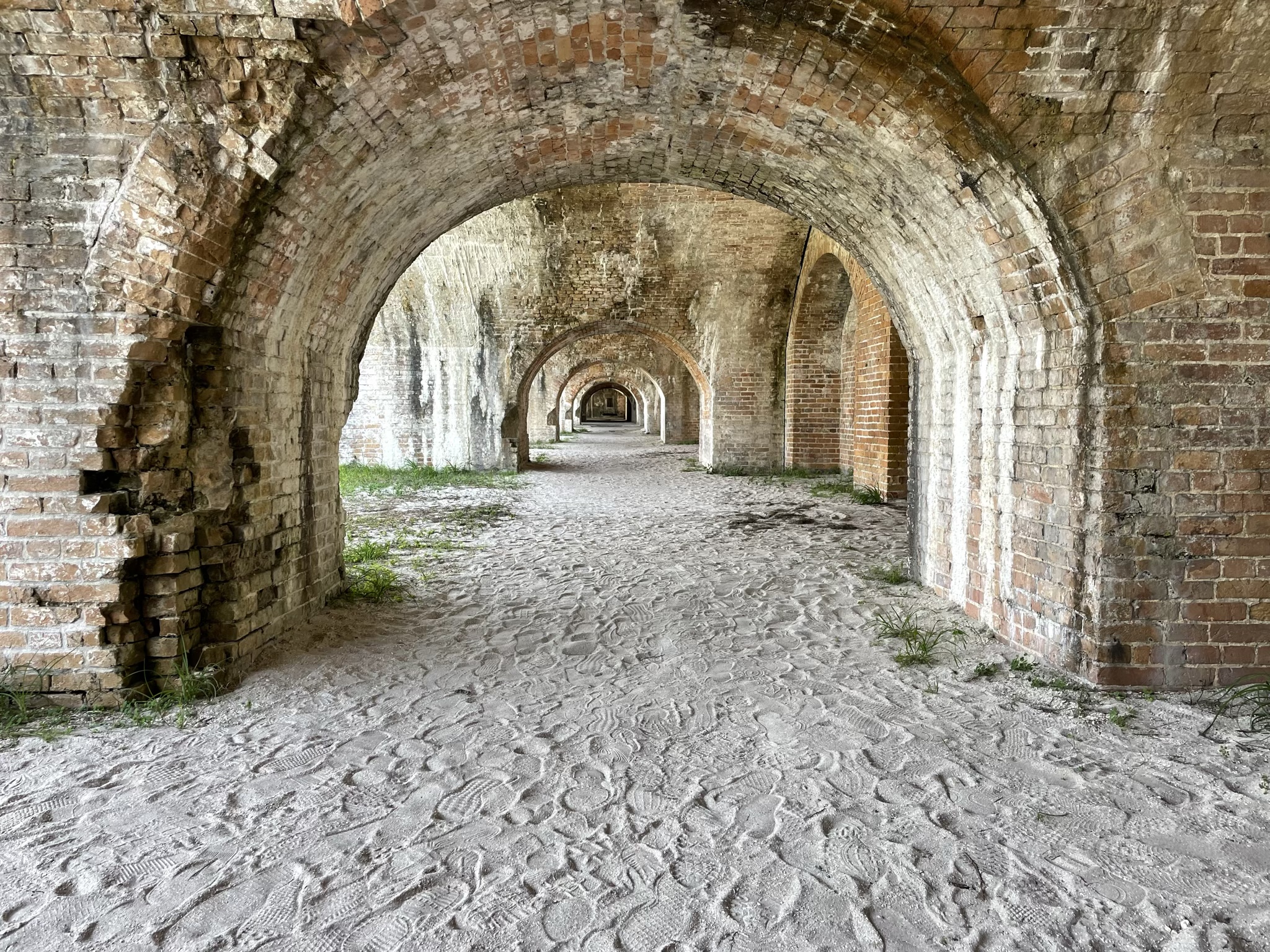 A photo of five archways in a row, stretching into the distance, inside the fort