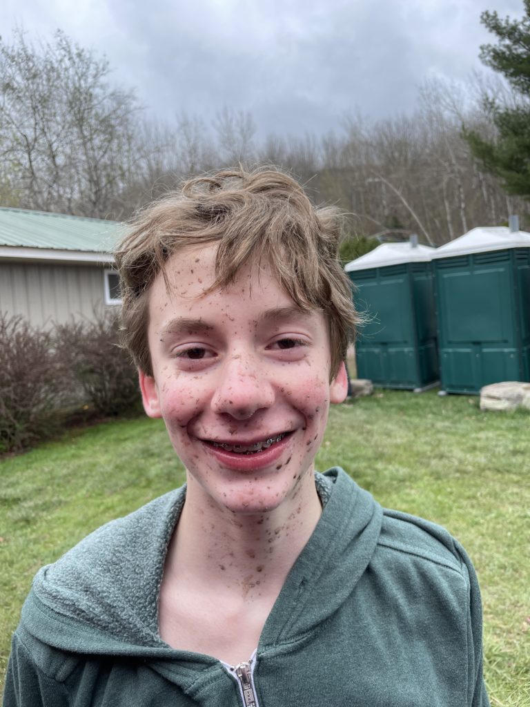 Dillon's muddy face post race at Walnut Mountain 2025.